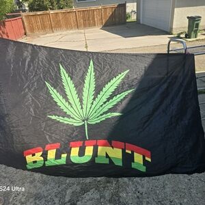 Black Flag with Green Leaf and Colorful Text